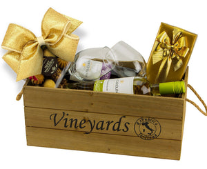 wooden gift box with red and white wine, wine glasses, chocolate box and cookies